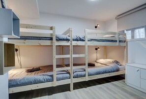 A bunk bed room with a desk and a cabinet. - Le Havre | Private Hot Tub | Hammock & Lake (Mansonville)