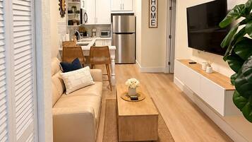 A modern living room with a sofa, coffee table, and a television.