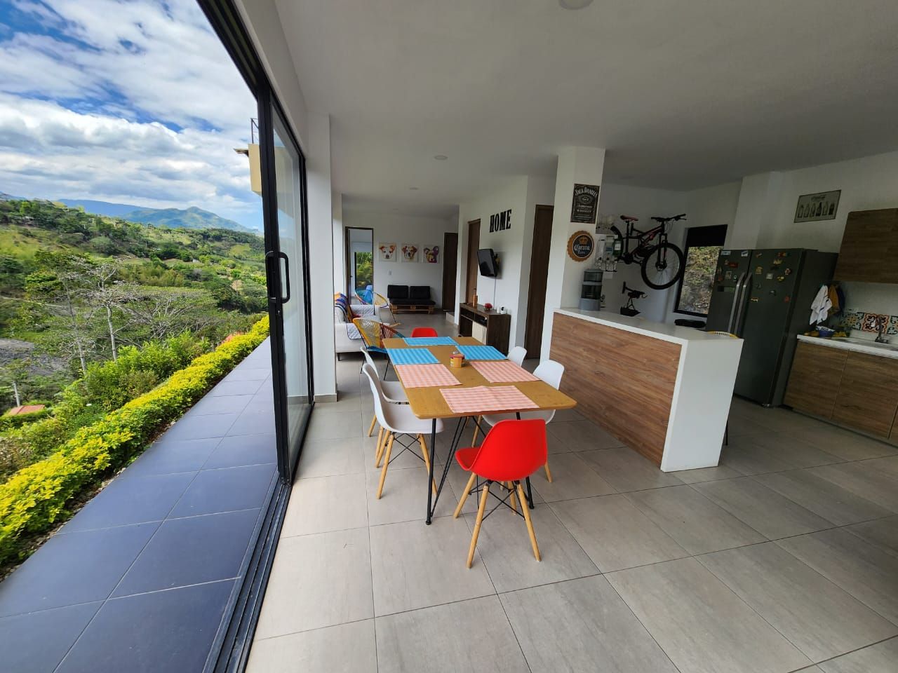 A modern kitchen with a wooden countertop and a refrigerator.