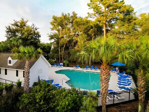 A swimming pool with blue lounge chairs and a small building with a sloped roof. - Rhythm & Tide-concerts. Coastlines. Charleston (Charleston)