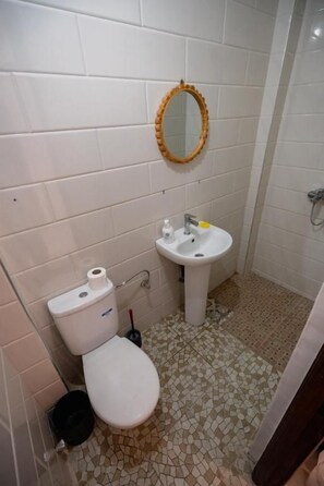A bathroom with a toilet, sink, and mirror. - Cheers Hostel (Aourir)