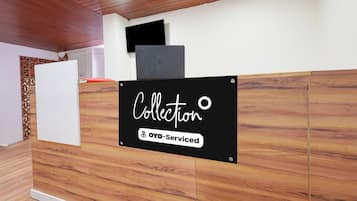 A reception desk with a sign that reads 'Collection' and 'Oyo-Serviced'.