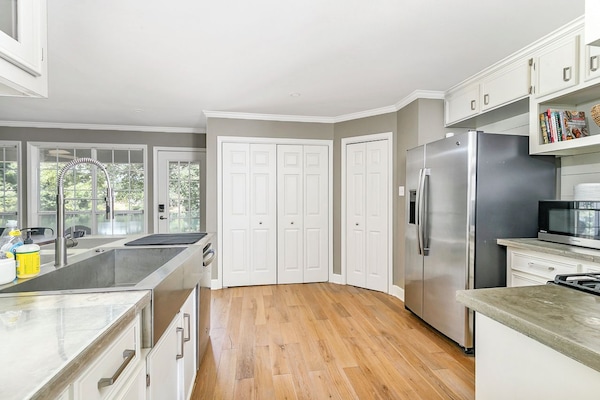 Bright, spacious kitchen with farmhouse sink and abundant storage