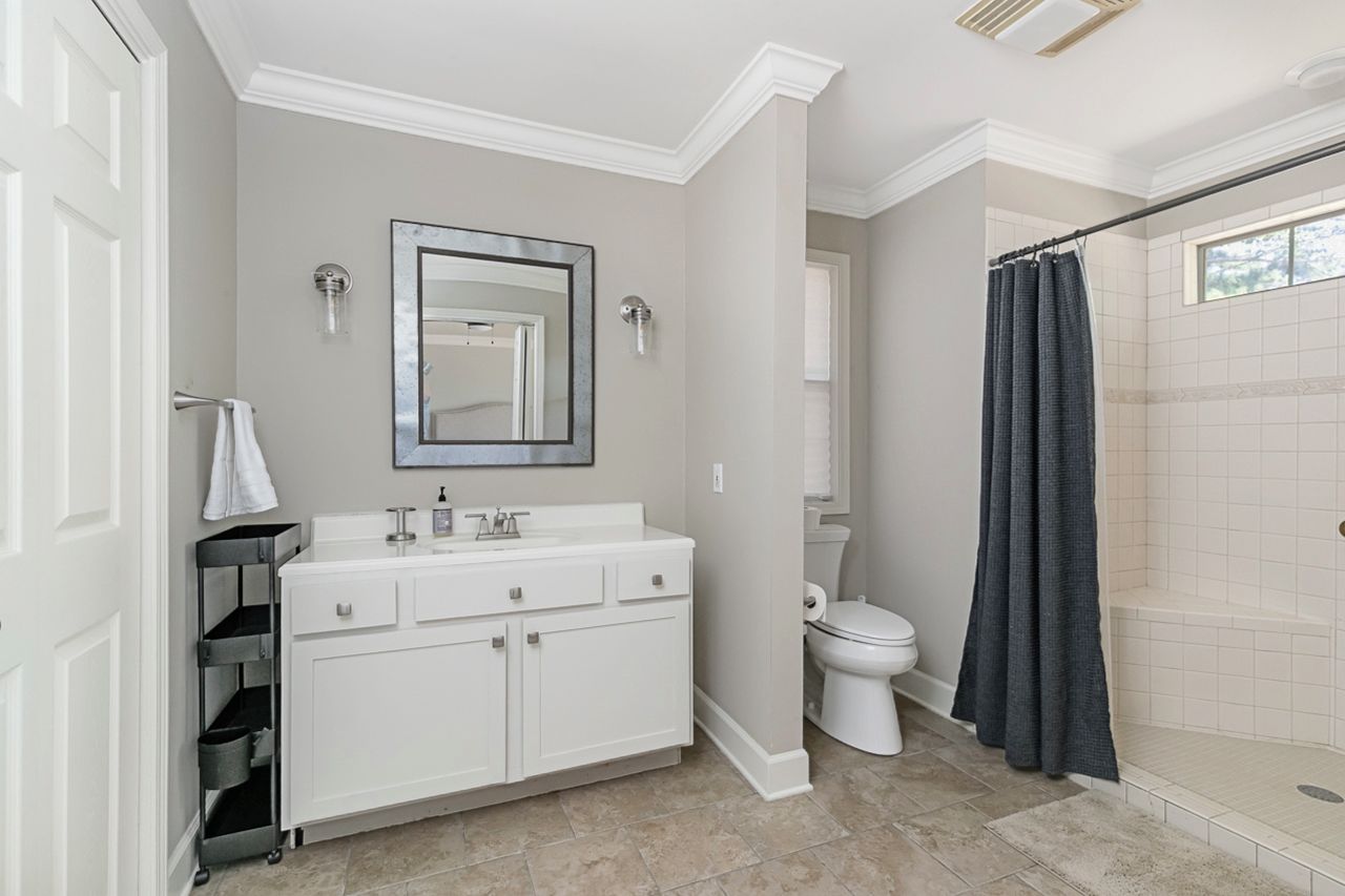 Bright, spacious bathroom with large vanity and tiled walk-in shower