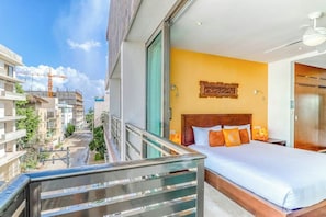A hotel room with a balcony overlooking a construction site. - 3BR Playa Condo: Rooftop Pool, Steps to 5th Ave (Playa del Carmen)