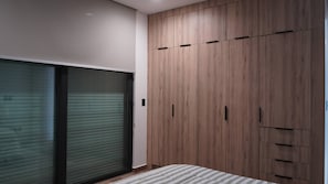 Bedroom with built-in wood closet and blackout shades - Torre W Beachfront Condo: Ocean View & Pools (Mazatlán)
