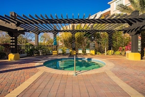 A pool area with a pergola, brick flooring, and a circular pool. - Luxury 3BR, Newly Renovated, Lake View, Vista Cay (Orlando)
