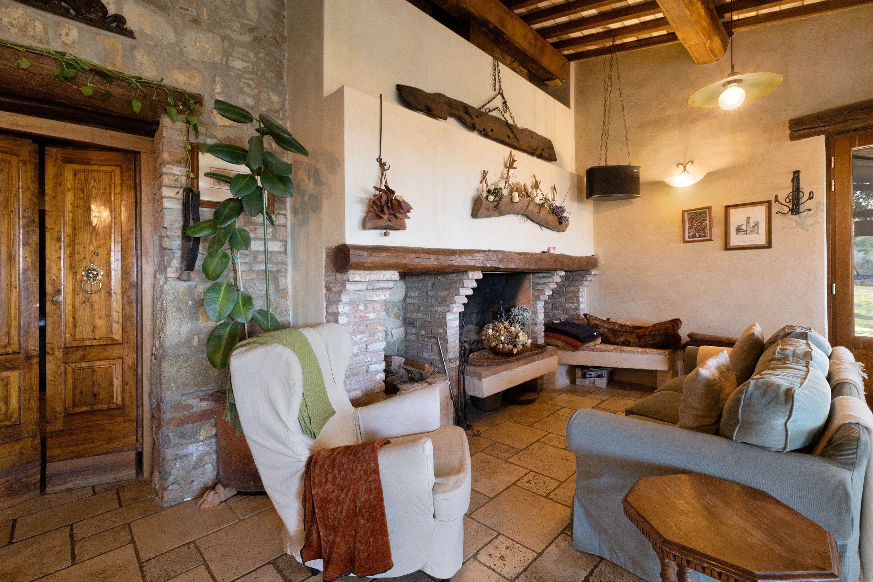 Una sala acogedora con chimenea, muebles de madera y pared de piedra.