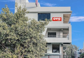A modern building with a sign for 'OYO ROOMS' indicating a hotel or accommodation. - Hotel O White Villa (, Nagpur)