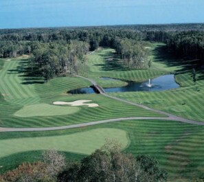 A golf course with multiple greens, sand bunkers, and a pond. - Villa 15 on Preserve Golf Course! (Pequot Lakes)