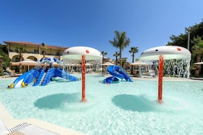 A swimming pool with water slides and lounge chairs. - Portes Beach Hotel (Nea Propontida)