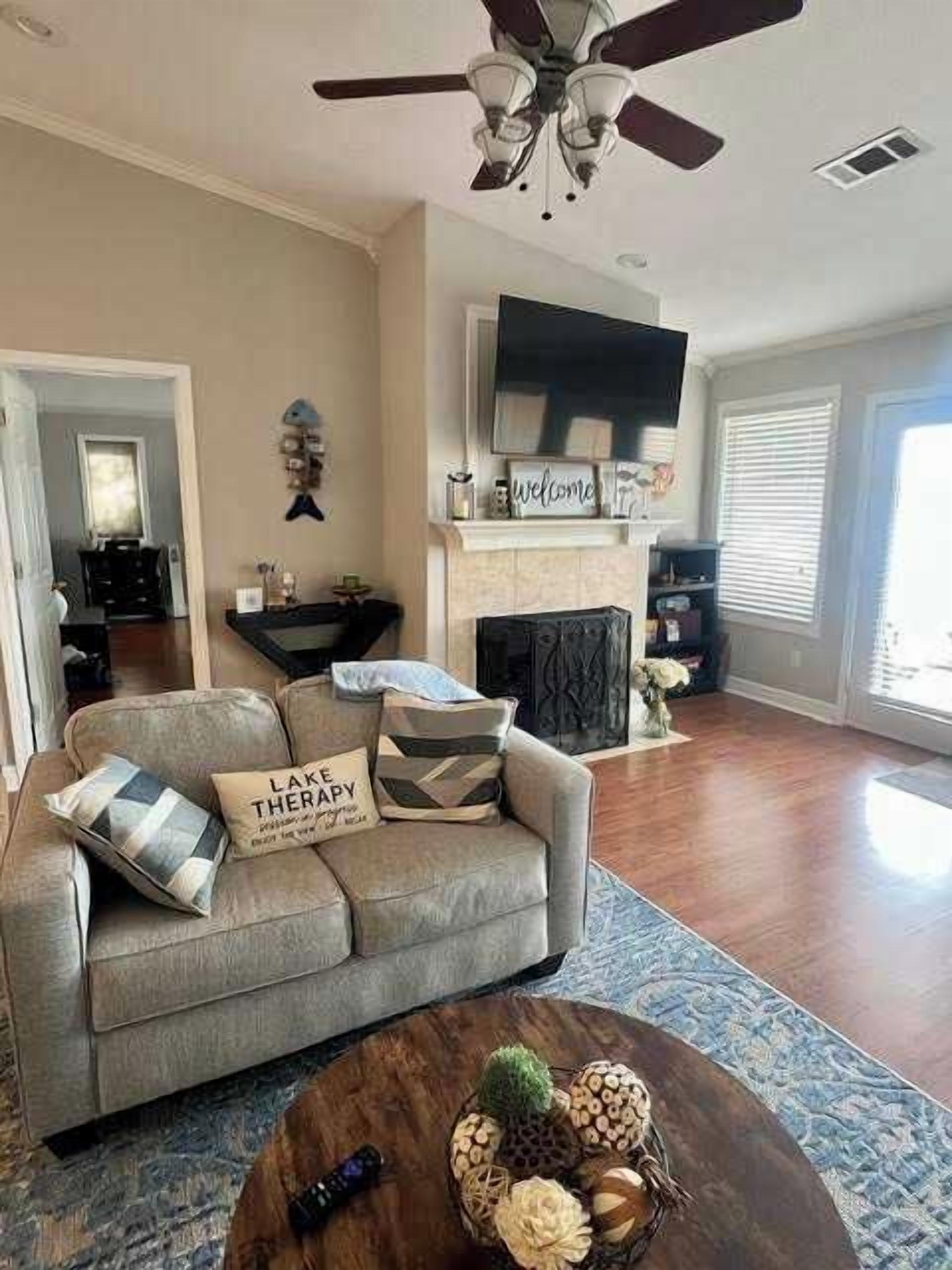 A living room with a sofa, coffee table, and fireplace.