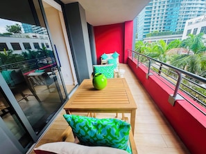 A balcony with a table, chairs, and a green vase. - All new at the campy Standard Residences and ready to be enjoyed 2br/2ba condo. (Miami)