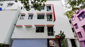 A multi-story building with a flat facade, multiple windows, and a ground-level entrance.