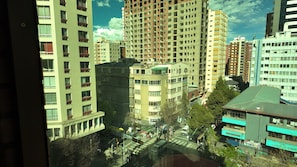 A multi-story building with a central courtyard, surrounded by other buildings. - hotel martí (La Paz)