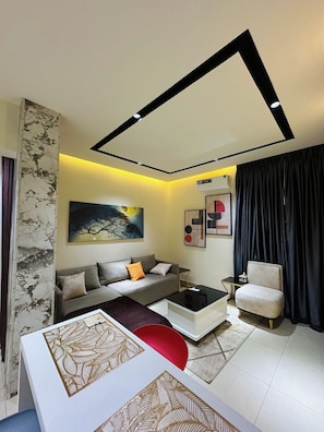 A modern living room with a sofa, coffee table, and a chair.