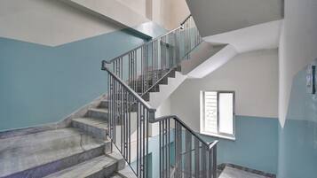 A staircase with metal railings leading to an upper floor.