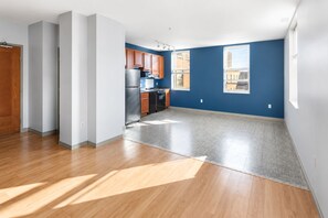 A spacious kitchen with wooden cabinets, a stainless steel refrigerator, and a dishwasher. - Flash Offer Cozy 1-bedroom condo in adorable Minneapolis for 1859/Month (Minneapolis)