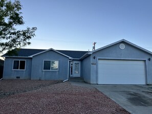 A single-story residential house with a garage, a front door, and a small porch area.