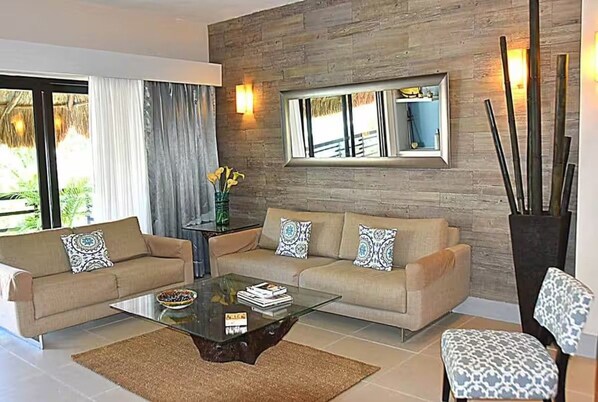 A modern living room with two sofas, a coffee table, and a large mirror. - Oceanfront @Mamitas Beach + Your Own Private Rooftop Paradise w/17' x 15' POOL (Playa del Carmen)