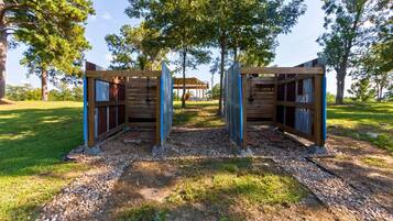 Une structure de pergola en bois avec un espace salon couvert en arrière-plan.