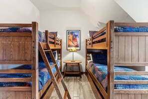 A room with bunk beds, a small table with a lamp, and a framed picture on the wall. - 3 bedroom Main Street Station Ski-in/out & Hot Tub (Breckenridge)