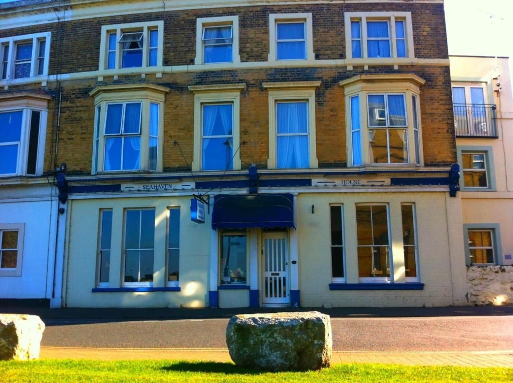 A multi-story building with a ground-floor shop named 'SEAHAVEN HOUSE.'