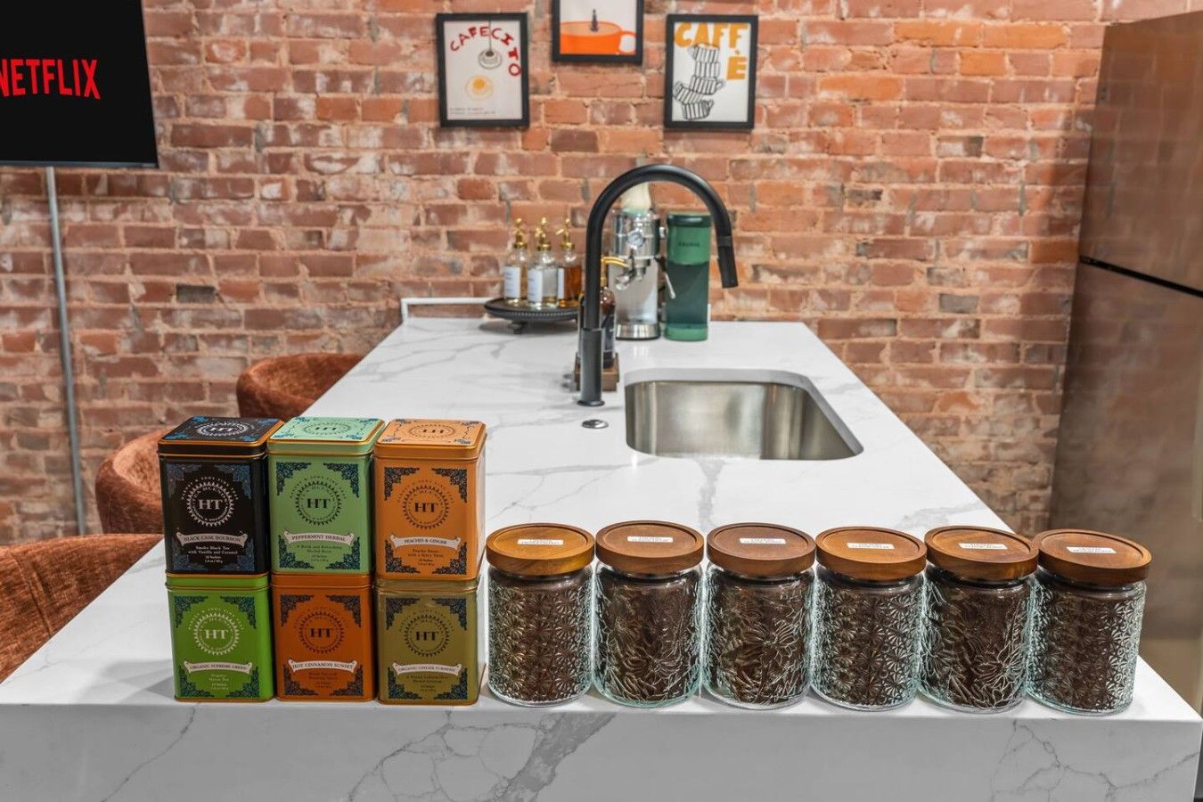 A kitchen counter with jars of spices and boxes of tea.
