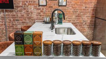 A kitchen counter with jars of spices and boxes of tea.