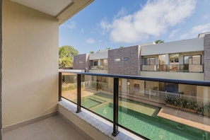A modern building with a flat roof, large windows, and a balcony with a glass railing. - Villa Vento #c03 - House in Cumbuco by Carpediem (Caucaia)