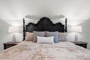 A bed with a quilted cover, a dark headboard, and multiple pillows. - Harbor Hollow: Hot Tub>Fire Pit>Water Front>Game Room (Jay)