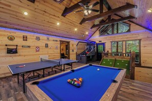 A wooden interior with a pool table, ping pong table, and a billiards table. - Brand-New Luxury Cabin • Private Pool • Game Room • Sleeps 18 (Sevierville)