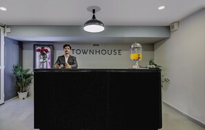 A reception desk with a sign reading 'TOWNHOUSE' and a coffee machine to the right.