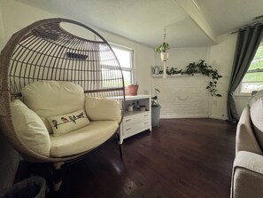 A room with a hanging chair, a white dresser, and a shelf with plants. - The Sherando Waypoint / Shenandoah Valley Escape (Stuarts Draft)
