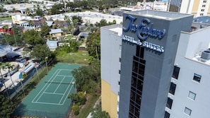 The Enclave Hotel & Suites with a tennis court visible in the background. - Enclave Studio Pools, Gym & Great Location (Orlando)