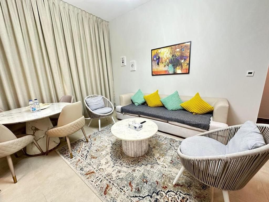 A modern living room with a sofa, chairs, a coffee table, and a dining table.