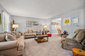 A living room with two sofas, a coffee table, and wall decorations. - ZEN ON O'RYAN  5 BEDROOM HOUSE IN OXFORD OHIO (Oxford)