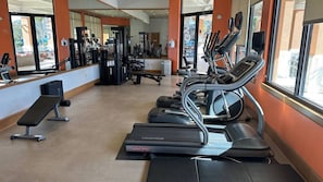 A gym with treadmills, weight machines, and benches. - 3BR Townhome at Regal Oaks Near Disney (Kissimmee)