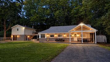 A two-story house with a covered porch and a garage.