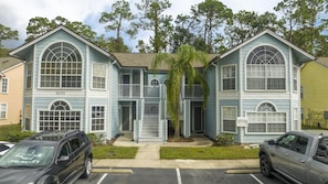 A two-story building with a garage, numbered 2031, and a central entrance with a small porch. - 3BR Condo Royal Bay Near Disney + Resort (Kissimmee)