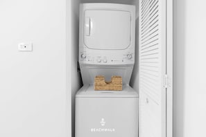 A white laundry room with a Beachwalk branded washing machine and dryer. - BW APT 2BR Resort Style Suite - Bay & City Views (Hallandale Beach)