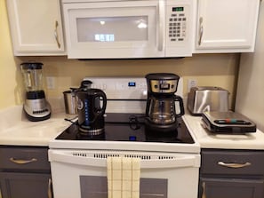 A kitchen with a microwave, coffee maker, toaster, and blender. - 3BR Home at Seven Dwarfs Resort w/ Pool (Kissimmee)