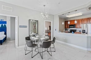 A modern kitchen with wooden cabinets, a microwave, and a refrigerator. - Vista Cay 3BR Condo w/ Balcony & Resort Pool (Orlando)