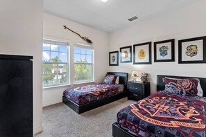 A bedroom with two beds, a window, and framed posters on the wall. - 4BR West Lucaya Home Near Disney (Kissimmee)