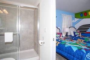 A bathroom with a glass shower enclosure and a toilet. - BR Villa w/ Pool, Star Wars Game Room + Resort (Davenport)
