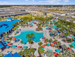 A resort with a large central pool, multiple smaller pools, and numerous sun loungers and umbrellas. - Themed 5BR Home w/ Pool · Windsor Island Resort (Davenport)