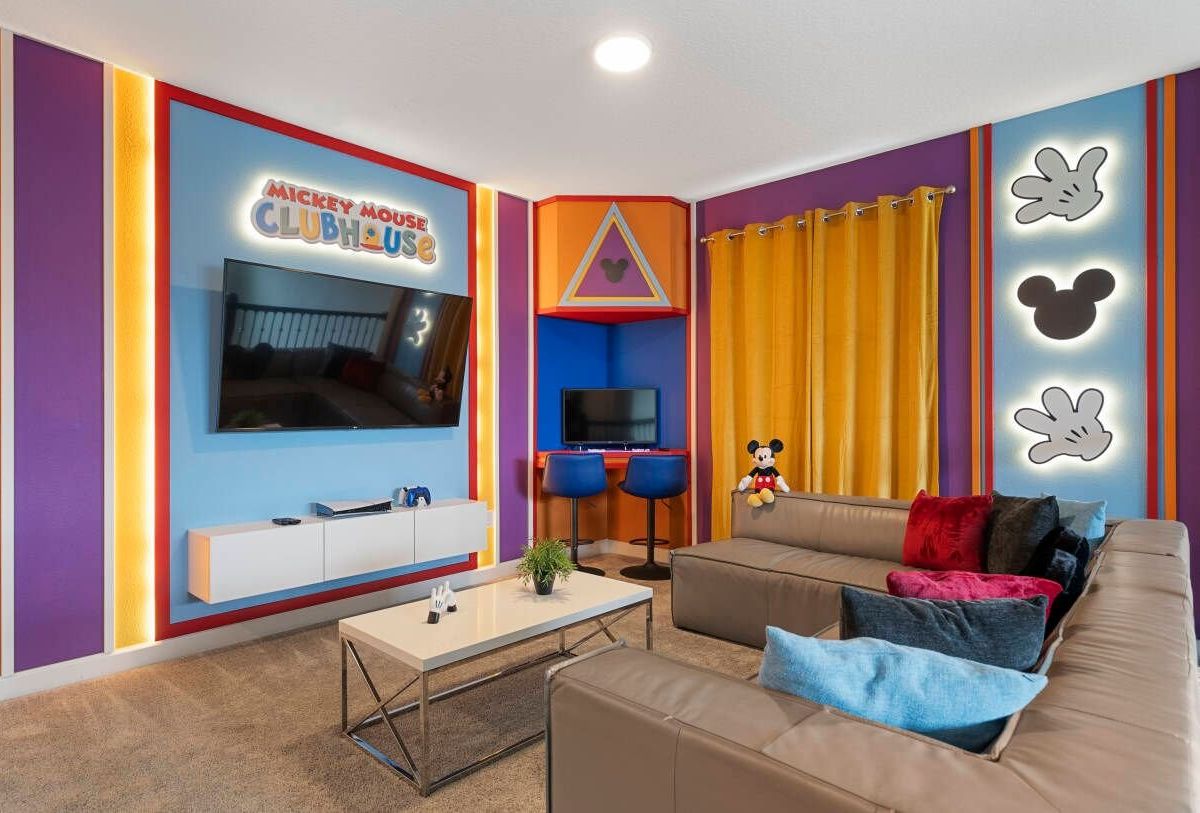Een woonkamer met een televisie, een bank en een salontafel.