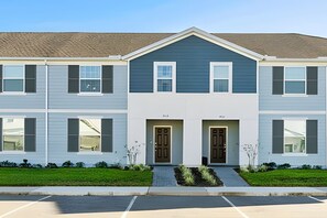 A two-story apartment building with a central entrance, two doors, and a small front garden. - Luxury 5BR Villa at Windsor Island Resort (Davenport)