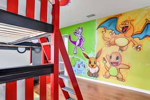 A bunk bed with a red and white striped headboard, a green wall with Pokémon characters, and a wooden floor. - Family 6BR Villa w/ Marvel Game Room & Pool (Kissimmee)