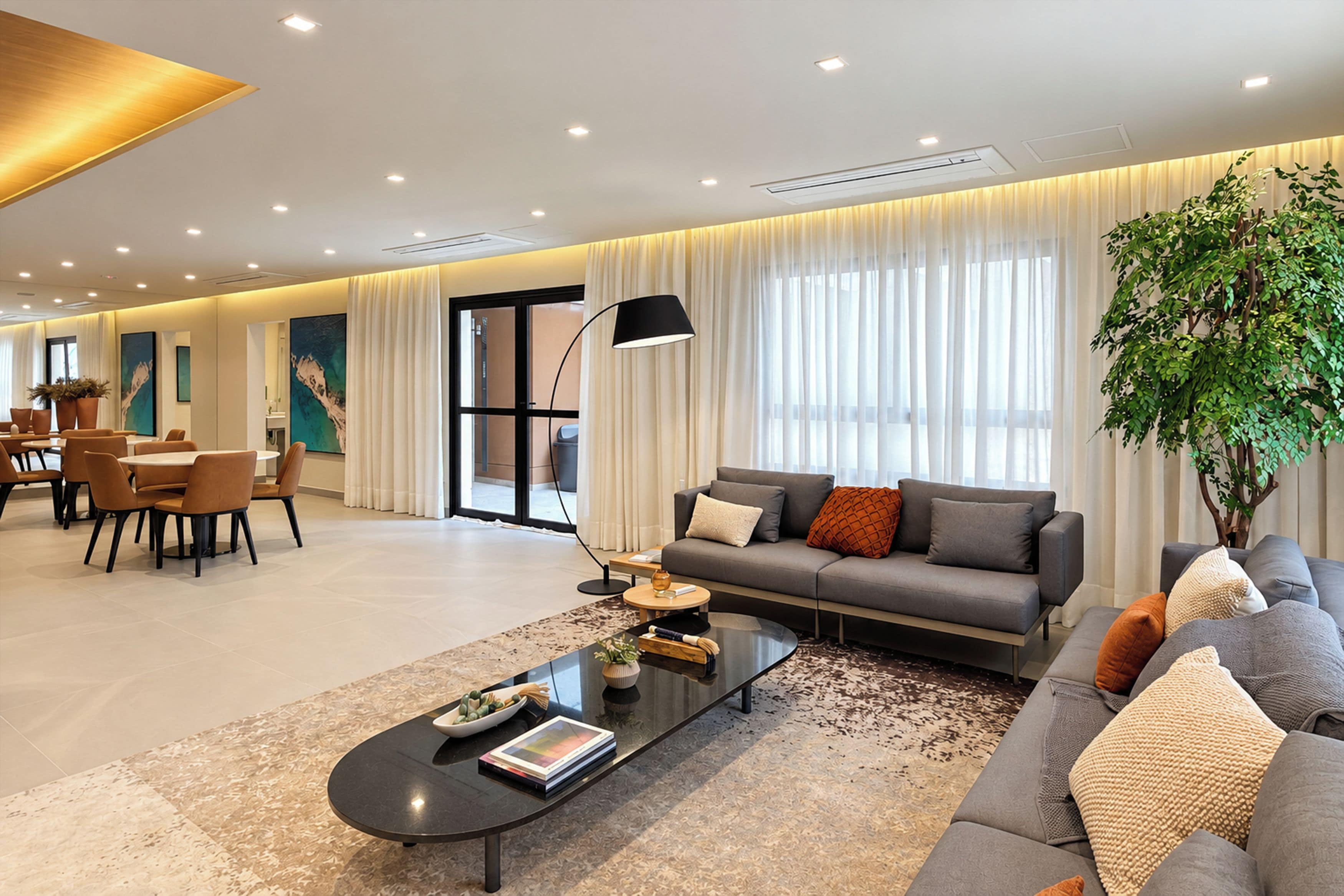 A modern living room with a sofa, coffee table, and dining area.